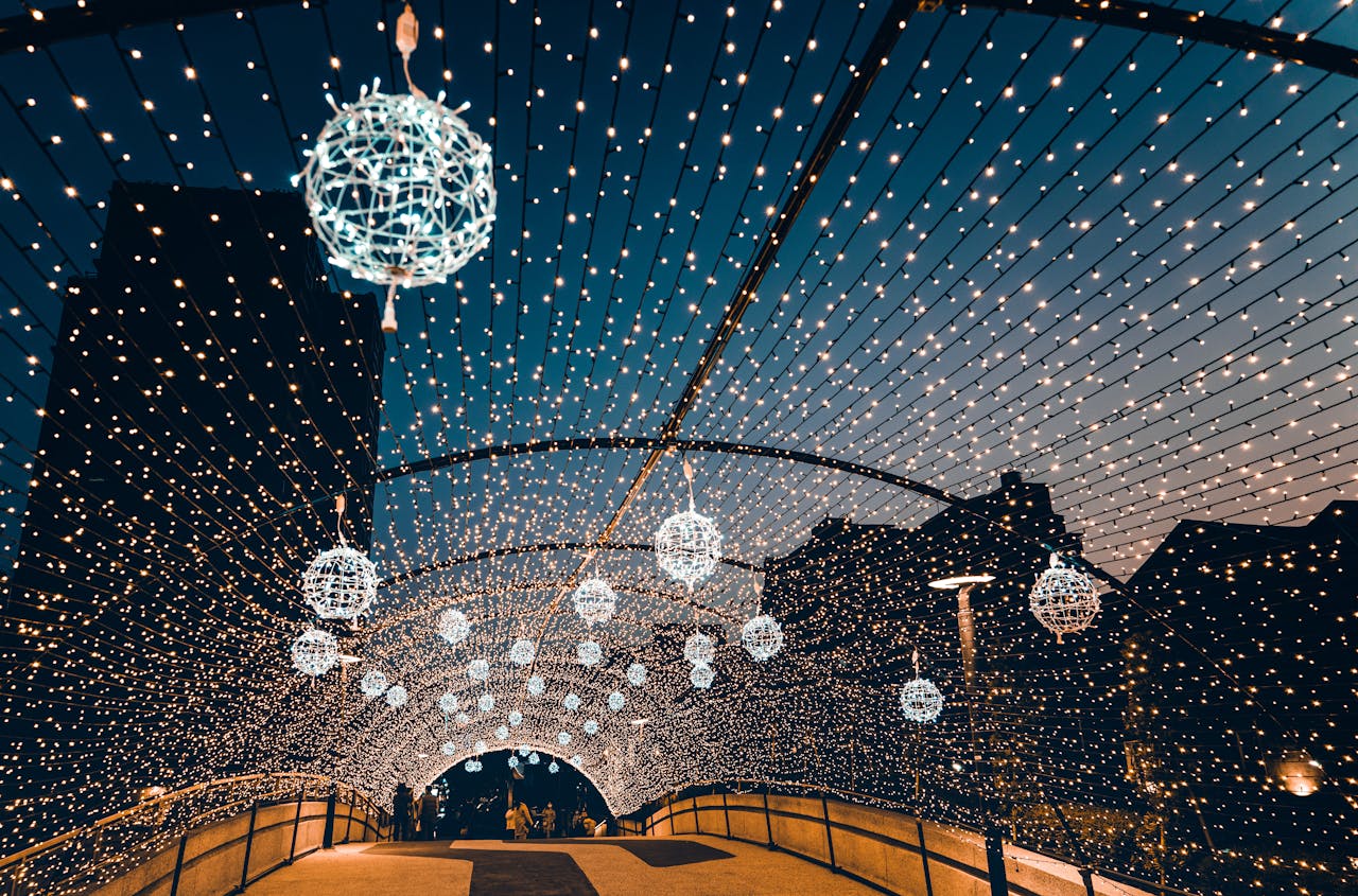 A beautifully lit bridge adorned with twinkling string lights, creating a festive ambiance during night time.